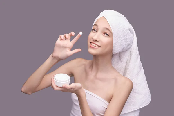 Chica joven aplicar crema anti edad. Rutina de cuidado — Foto de Stock