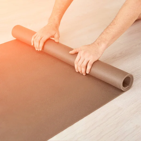 Yoga person rolling sport mat. Grey color. Gym carpet — Stock Photo, Image