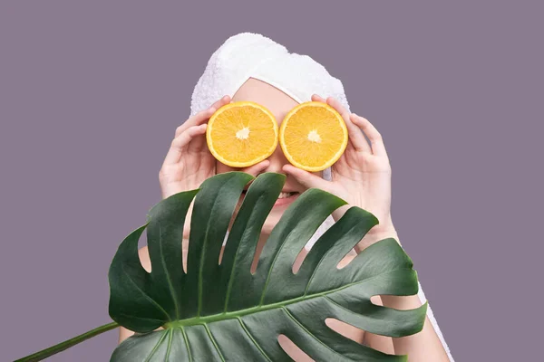 stock image Girl hold orange slice. Citrus fruit hidding face