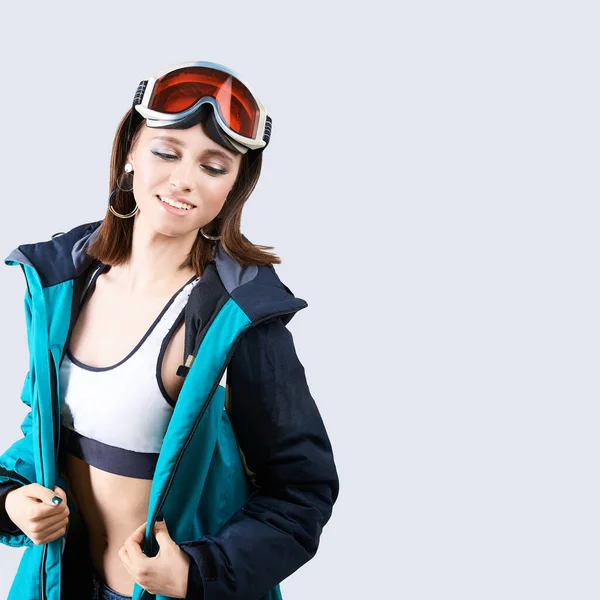 Beauty sport girl. Snowboard jacket. Pretty young woman in fitness clothes