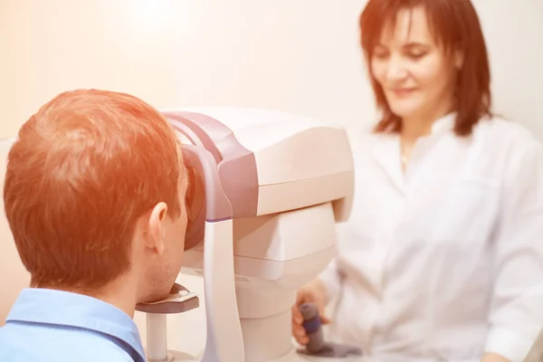 Ophthalmologist doctor in exam optician laboratory with male patient — Stock Photo, Image