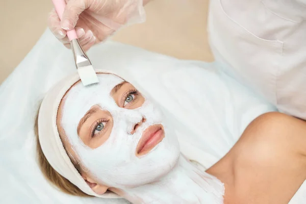 Portrait of moisturizing mask on white background for medical design. Woman