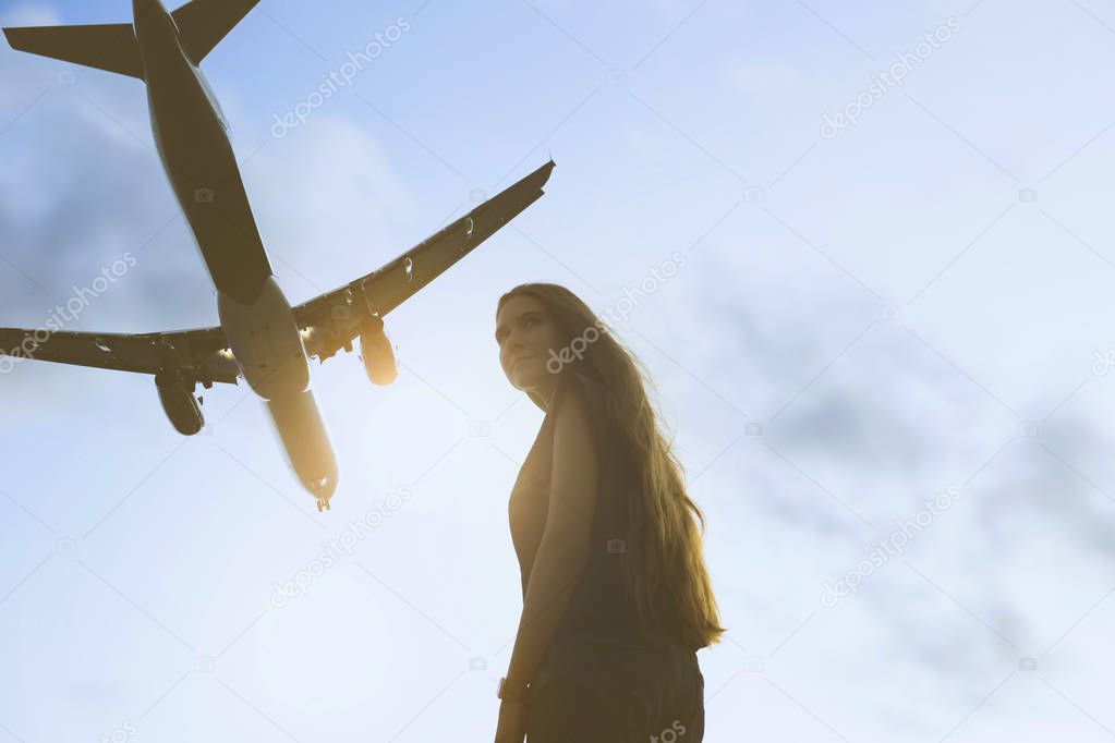 Young woman and plane. Travel vocation concept.