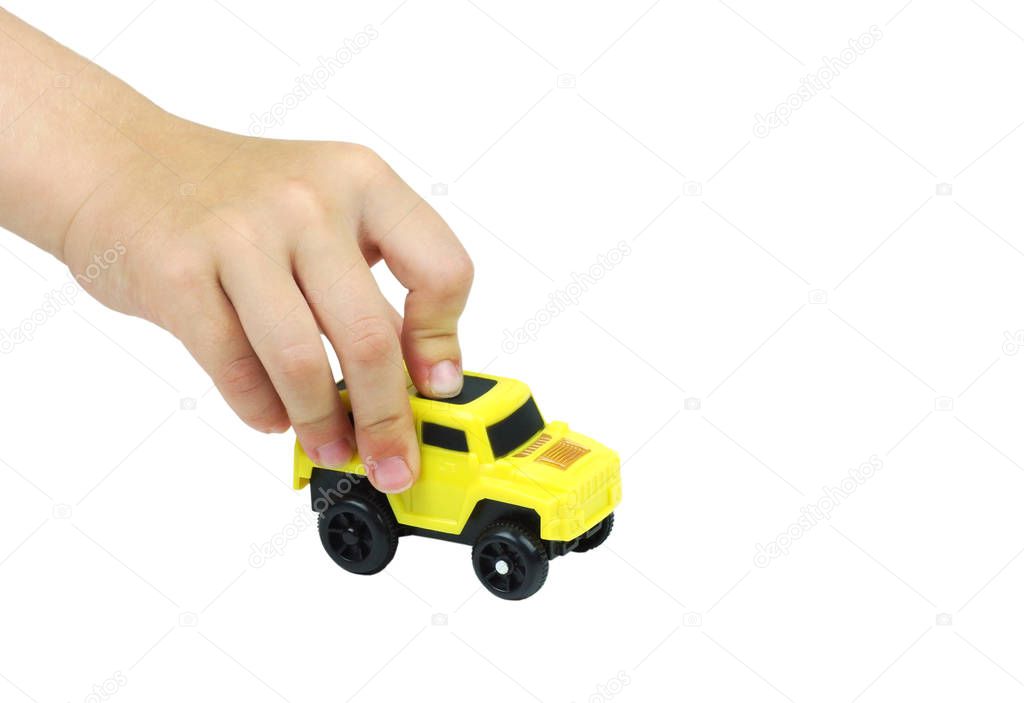Children's hand with a yellow car. Isolated on white.                               