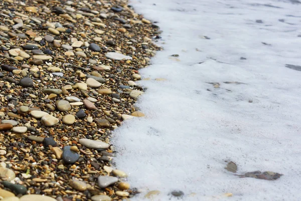 Vågen rullar på den steniga stranden. — Stockfoto