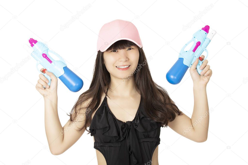 Sexy Chinese American woman wearing a black one piece swimsuit and playing with blue water guns isolated on a white background