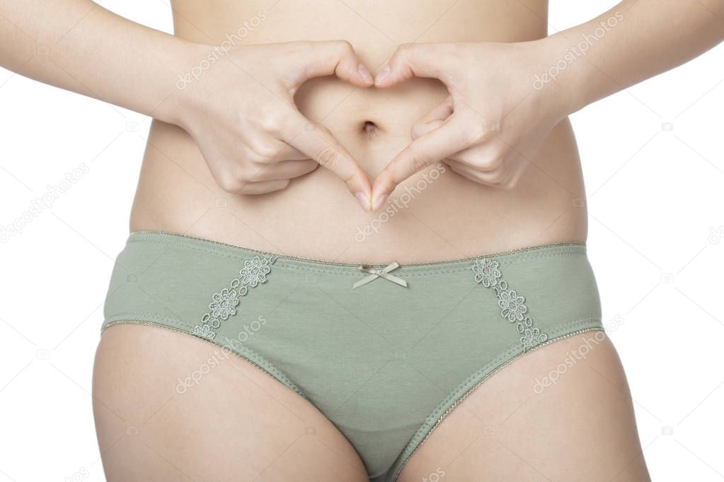 Beautiful Chinese woman posing in a pair of green panties and bra isolated on a white background. panties and bra isolated on a white background.