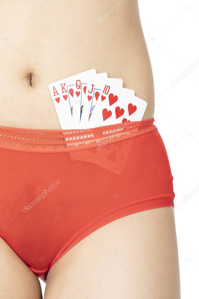 Beautiful Chinese woman posing in red panties with playing cards isolated on a white background.