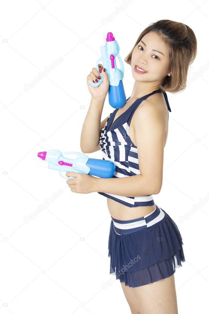 Sexy Chinese American woman wearing a bikini swimsuit and playing with blue water guns isolated on a white background