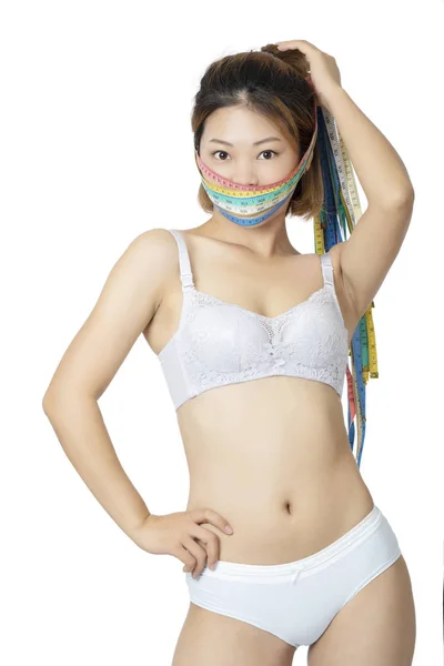 Foto de Chinese woman posing in panties and bra on white background do  Stock