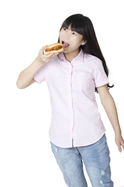 Chinese American woman eating Chicken Sandwich isolated on white — Stock Photo, Image