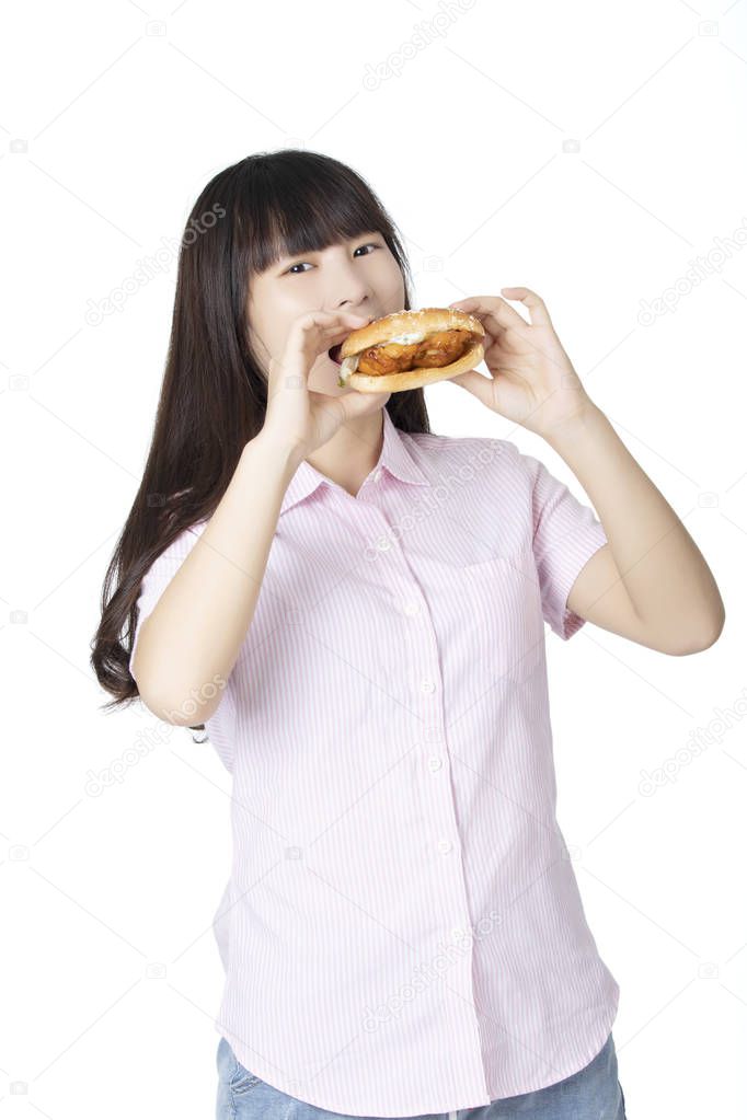 Chinese American woman eating Chicken Sandwich isolated on white