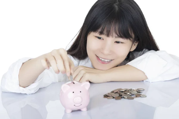 Female depositing American coins piggy bank isolated, white back — Stock Photo, Image