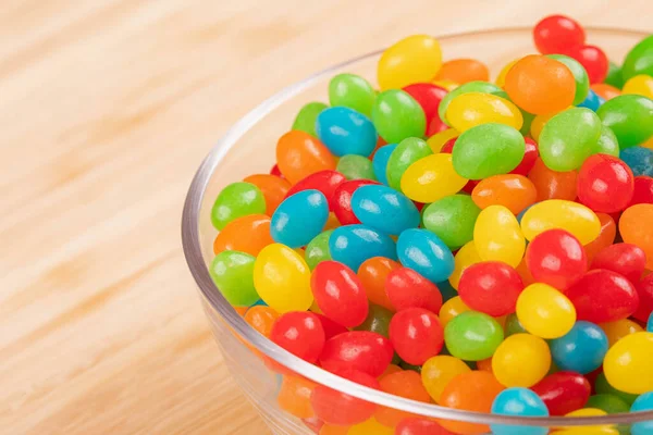 Close Delicious Jelly Beans Candy Glass Bowl Isolated Wooden Background — Stock Photo, Image