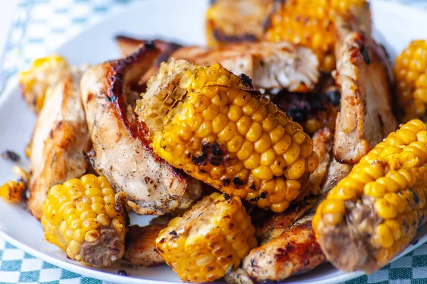 Fried corn and meat, close up on a plate