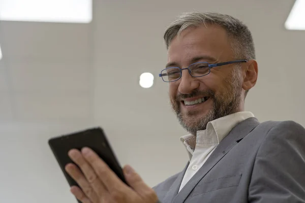 Happy Mature Businessman With Digital Tablet Standing in Office — Stock Photo, Image