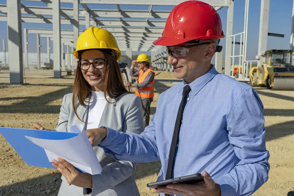 Smiling Female Architect and Mature Businessman Meeting on Construction Site — Stock Photo, Image