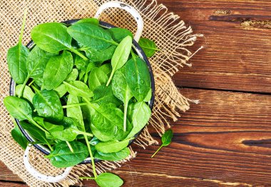 Ahşap bir arka planda taze ıspanak yaprakları