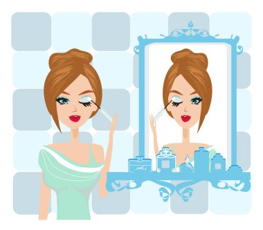 Güzel kız makyaj yapıyor.