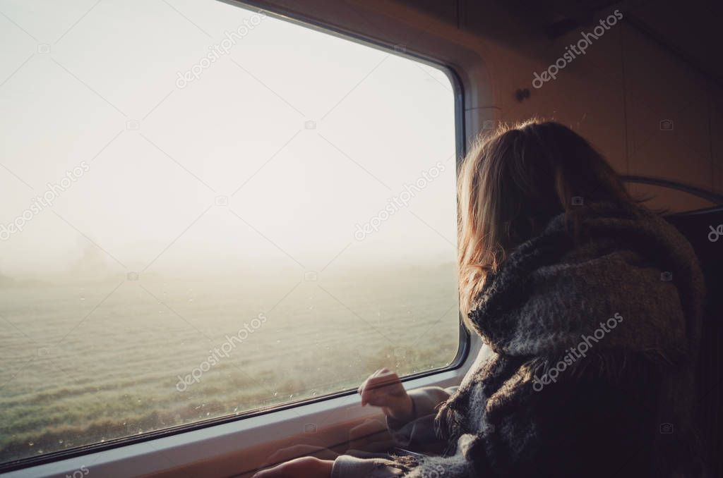 Girl in train looking through window