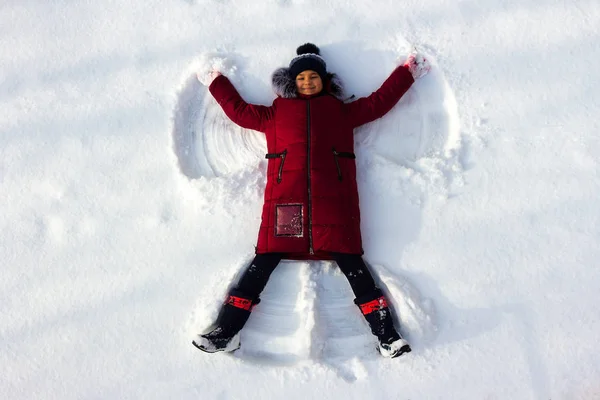 Young Girl Makes a Snow Angel