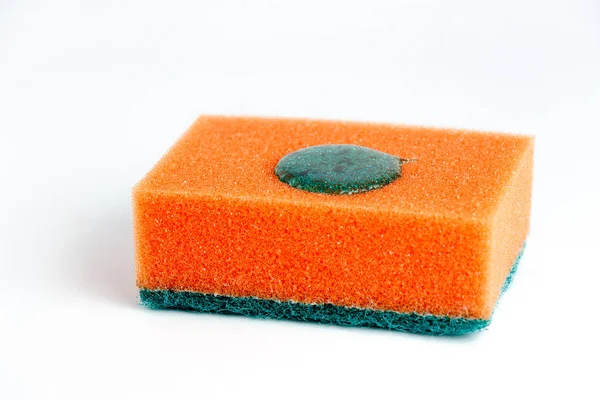 Sponge for washing dishes on a white background with a drop of detergent. Isolated on white background.