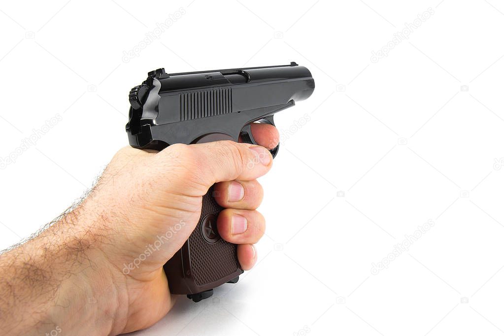 Hand holds a gun isolated on white background