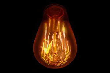 Koyu bir arka plan üzerinde güzel filament ile ampul