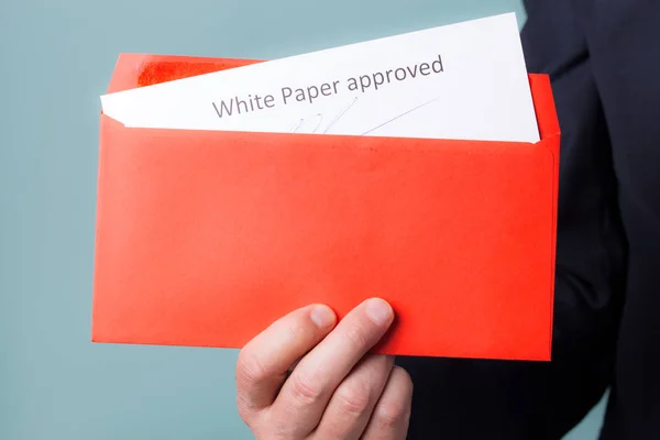 Envelope White Paper approved in the hands of men. The concept of preparation for the ICO.