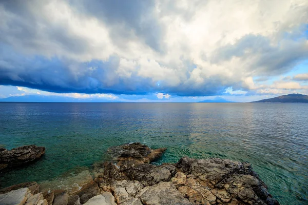 Stones against the background of the sea and storm clouds in the sky. Resort Bodrum in Turkey. Gulfs and sea bays in the Aegean Sea.