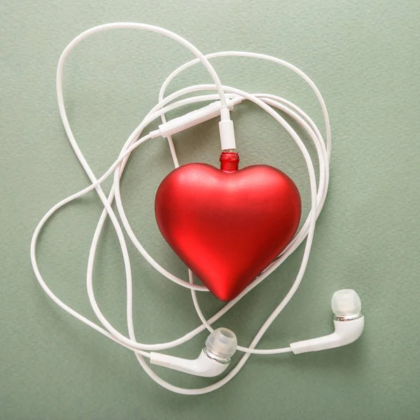 The concept of Valentine's Day. Purple heart and headphones as a symbol of the music of a loving heart.