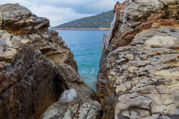 Large rocks of shell rock on the shore of the Aegean Sea. District Bodrum, resorts of Turkey.