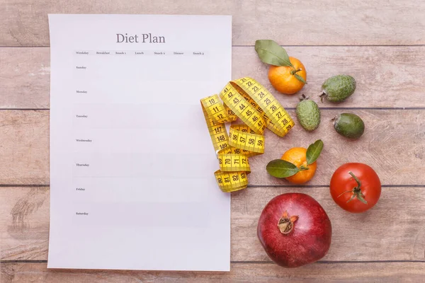 A diet plan template for each day of the week. Juicy fruit and a ruler is a symbol of a harmonious figure and health benefits.