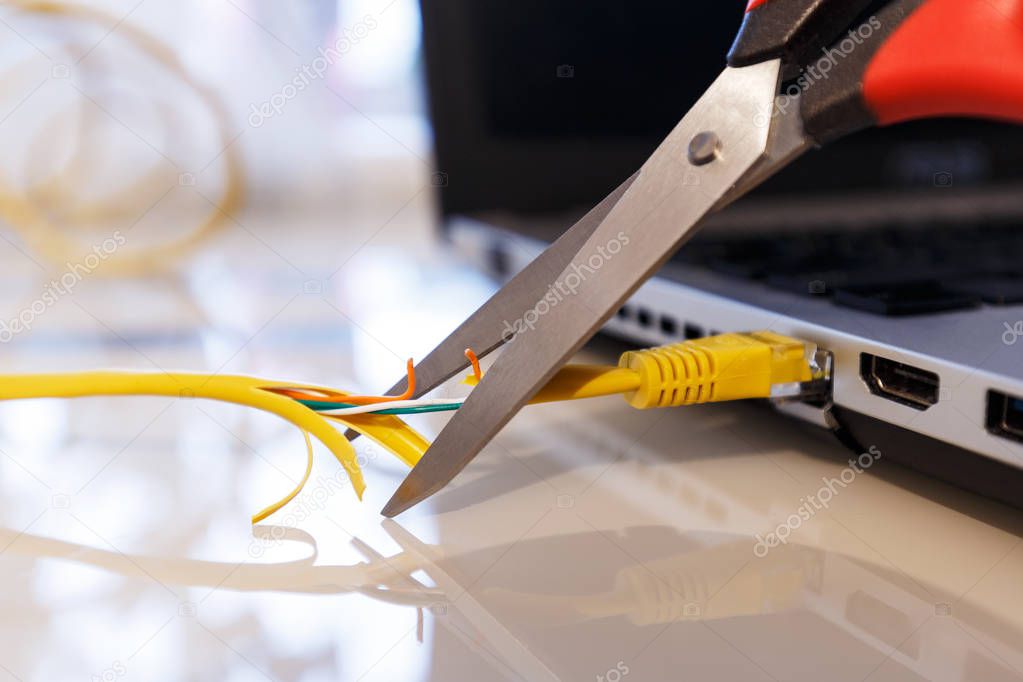 Scissors cut the Internet cable as a symbol of blocking access to the Internet. Can illustrate the loss of data.