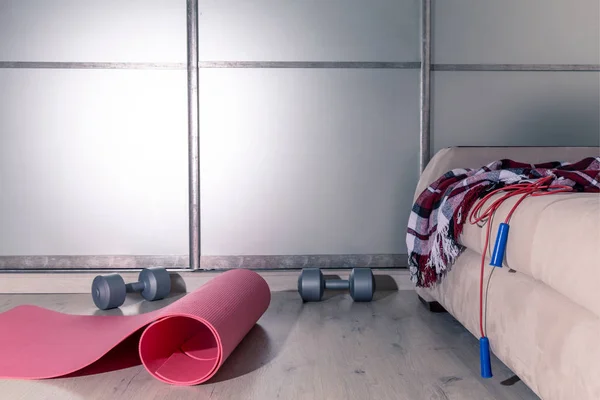 Fitness at home and home workout. Sports equipment for exercise housewives.