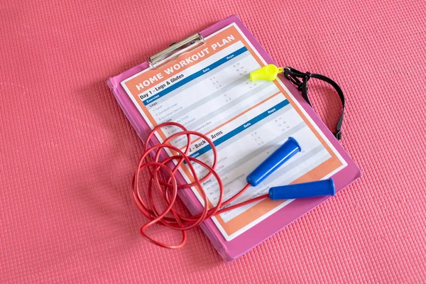 Fitness at home and home workout. On the sports mat is the inventory for the housewife exercises.