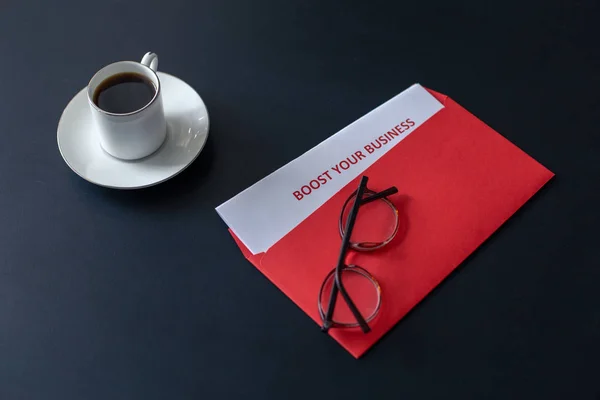 Boost your business is written on a sheet in a red envelope