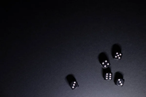 The concept of development and design of games. Dice on a dark background as a symbol of gaming.