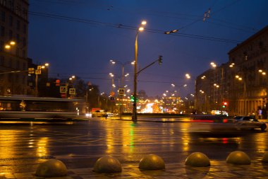 Gece yağmur sonra büyük bir şehirde araba ışıklar.
