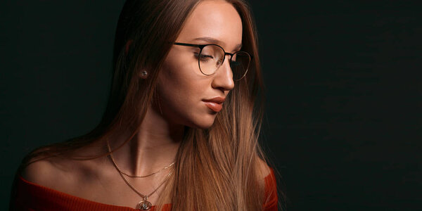 Beautiful blonde girl with long hair in glasses. European fashion model and natural beauty.