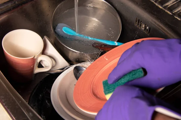 Dirty dishes in the kitchen sink. The concept of routine homework and washing plates.