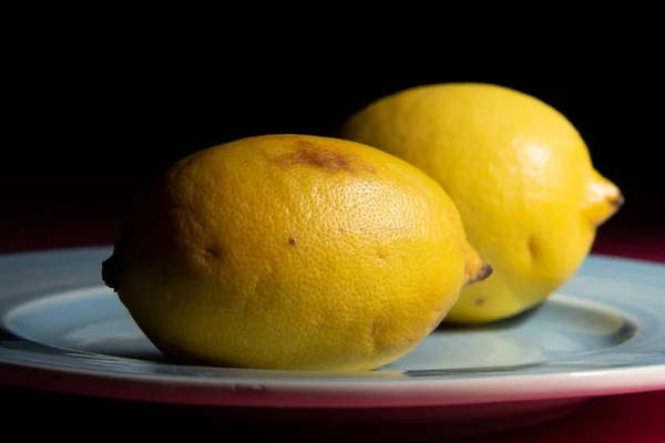 Spoiled lemon was covered with dark spots. The concept of storage products and shelf life.