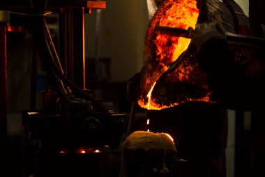 Dökme demir ve çelik için eritme fırını ve fabrika ekipmanları. Erimiş sıvı metal kalıba dökülüyor..