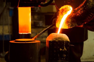 Erimiş metal kalıba dökülüyor. Dökme demir, çelik ve sıvı metal için eritme fırını.