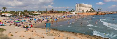 Beautiful October sunshine and hot weather drew holidaymakers and visitors to the sandy beach at La Zenia, Spain on Friday 5th October 2018 clipart