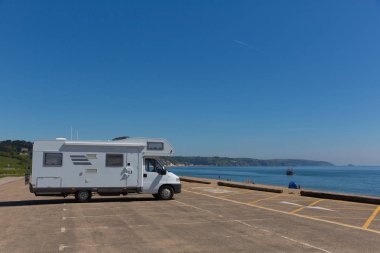 Motorhome parked in car park by the beach Slapton Sands England UK clipart