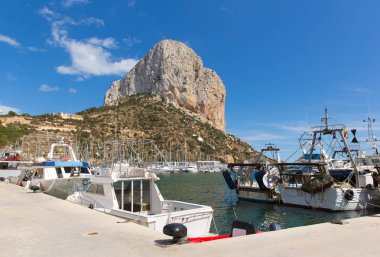 Calp Spain marina with boats and Penon de Ilfach the famous rock landmark clipart