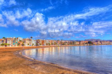 Puerto de Mazarron Murcia Spain beach and sea with bright vivid colours clipart