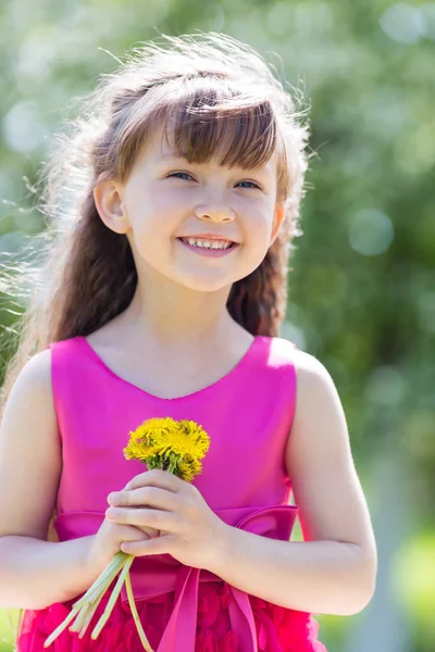 Dziecko Siedzi Trawie Parku Żółtych Kwiatów Dziewczynka Trzyma Bukiet Kwiatów — Zdjęcie stockowe