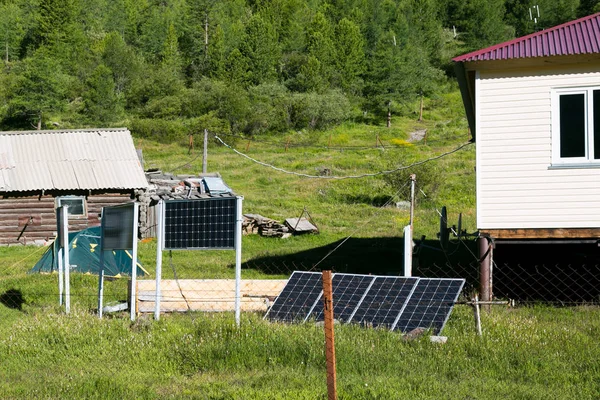 The weather station building is weather forecasters, powered by solar panels. Solar panels on a weather station in the mountains.